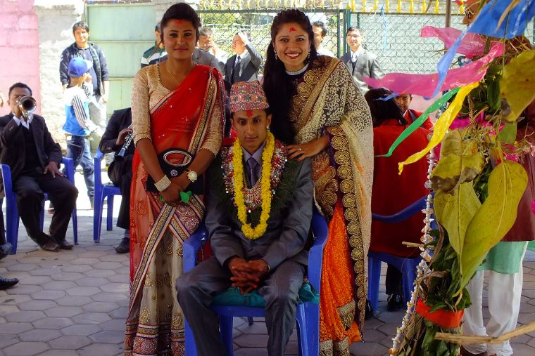 A newly married couple seated together, smiling