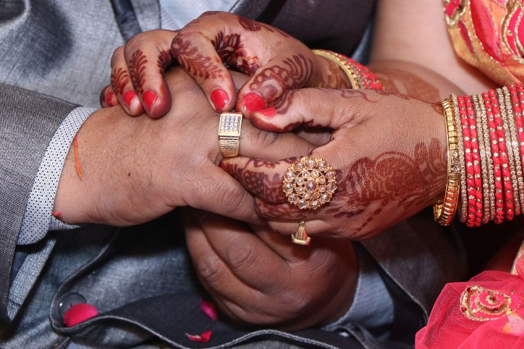 Hands with henna joined during an engagement