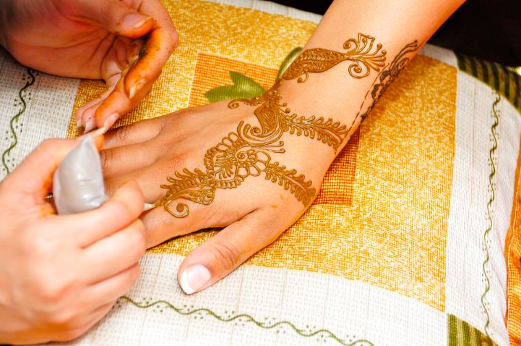Henna being applied to a bride's hand