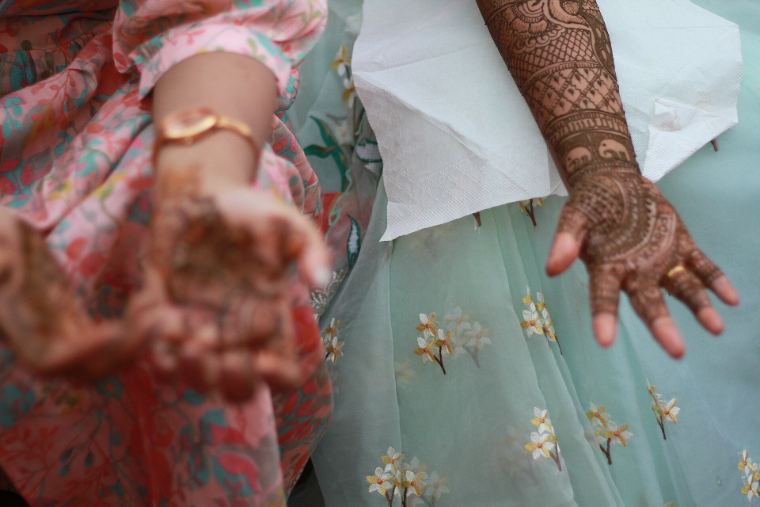A bride showing intricate henna on her hands